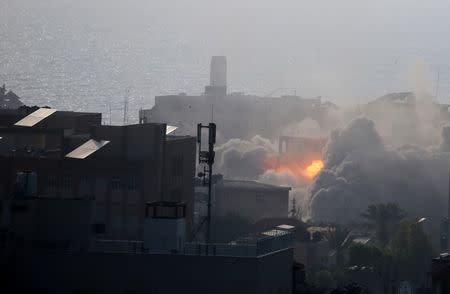 An explosion is seen following an Israeli strike on a building in Gaza City July 14, 2018. REUTERS/Ibraheem Abu Mustafa