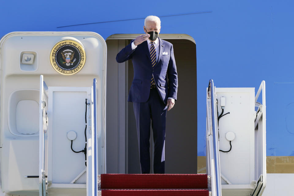 President Joe Biden salutes from the the top of the steps of Air Force One at Andrews Air Force Base, Md., Tuesday, Jan. 11, 2022. Biden is traveling to Georgia to give a speech endorsing changing the Senate filibuster rules that have stalled voting rights legislation, saying it's time to choose "democracy over autocracy." But some civil rights groups won't be there, in protest of what they say is administration inaction. (AP Photo/Susan Walsh)