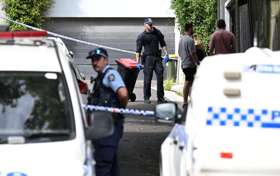 Police officers work at the crime scene at Waite Road in Paddington, Sydney