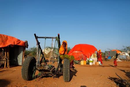 Zeinab's sister Farhiya, 6, sits on a cart near her family's shelter at a camp for internally displaced people from drought hit areas in Dollow, Somalia April 4, 2017. REUTERS/Zohra Bensemra