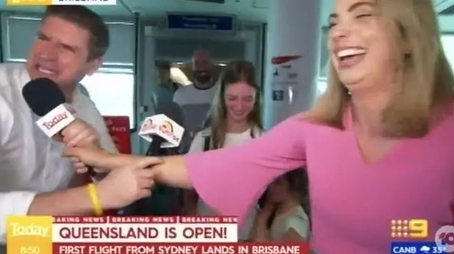 Reporters for Today and Sunrise clashed while interviewing passengers on the first flight from NSW to QLD. Photo: Channel 10.
