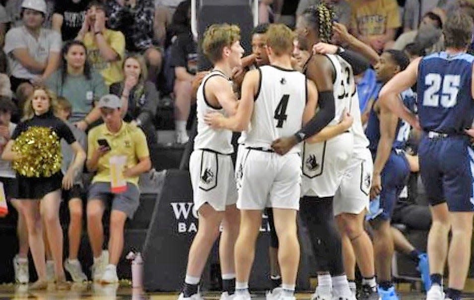 Exeter's Josh Morissette (4) huddles with his Wofford University men's basketball teammates during a game against Gardner Webb last season. Morissette will transfer and play for Saint Anselm College next year.
