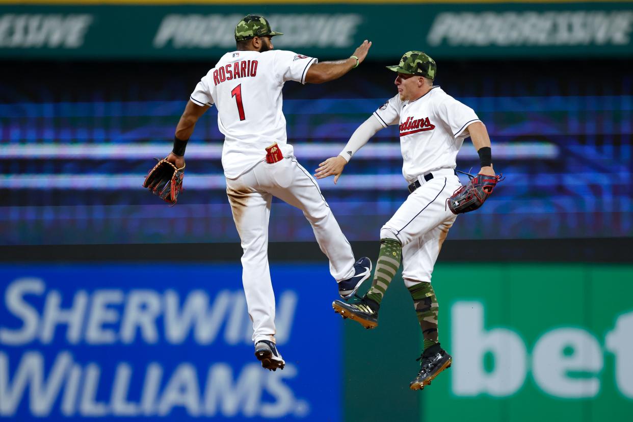 Guardians shortstop Amed Rosario (1) and center fielder Myles Straw celebrate a 6-1 win over the Detroit Tigers on Friday. [Ron Schwane/Associated Press]