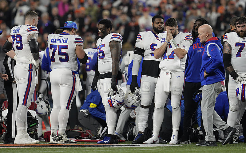 Buffalo Bills quarterback Josh Allen (17) pauses and turns away as Damar Hamlin is examined during the first half of an NFL game against the Cincinnati Bengals, on Jan. 2 in Cincinnati. <em>Associated Press/Jeff Dean</em>