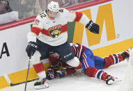 Florida Panthers' Gustav Forsling (42) lies on the ice below Montreal Canadiens' Michael Pezzetta (55) during the third period of an NHL hockey game Thursday, March 30, 2023, in Montreal. (Graham Hughes/The Canadian Press via AP)