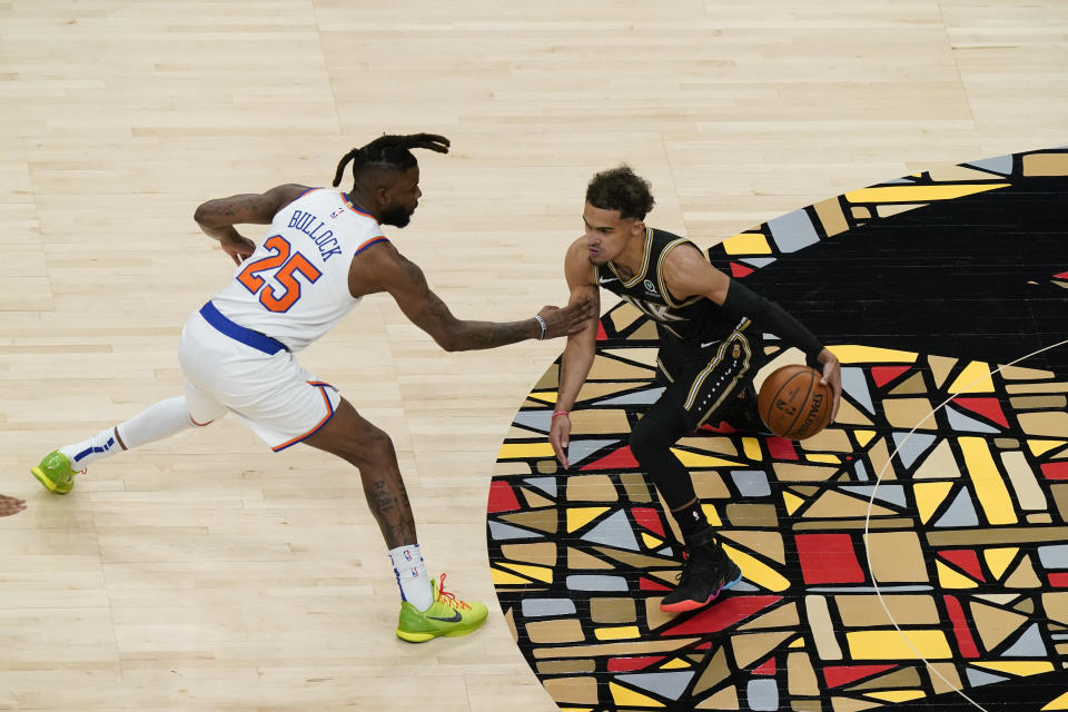 Atlanta Hawks' Trae Young, right, dribbles against New York Knicks' Reggie Bullock (25) during the first half in Game 4 of an NBA basketball first-round playoff series Sunday, May 30, 2021, in Atlanta. (AP Photo/Brynn Anderson)