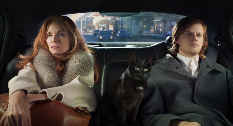 Michelle Pfeiffer and Lucas Hedges sit in the back of a car with a cat