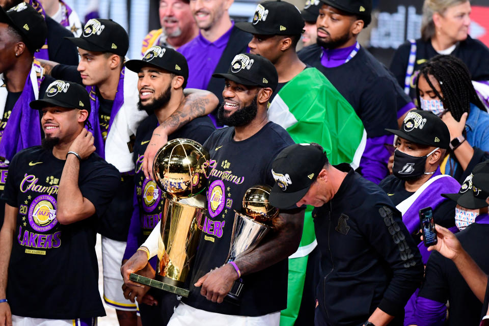 LAKE BUENA VISTA, FLORIDA - OCTOBER 11: LeBron James #23 of the Los Angeles Lakers reacts with his MVP trophy and Finals trophy after winning the 2020 NBA Championship over the Miami Heat in Game Six of the 2020 NBA Finals at AdventHealth Arena at the ESPN Wide World Of Sports Complex on October 11, 2020 in Lake Buena Vista, Florida. NOTE TO USER: User expressly acknowledges and agrees that, by downloading and or using this photograph, User is consenting to the terms and conditions of the Getty Images License Agreement.  (Photo by Douglas P. DeFelice/Getty Images)