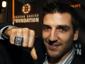 FILE - Boston Bruins NHL hockey forward Patrice Bergeron displays his Stanley Cup Championship ring to members of the media outside the Boston Harbor Hotel, in Boston, Tuesday, Oct. 4, 2011, following the unveiling of the rings during ceremonies for the hockey team. Bruins forward Patrice Bergeron has retired. The five-time Selke Trophy winner announced Tuesday, July 25, 2023, that he will not return for a 20th season with the only team he has ever played for. The Bruins captain said he is leaving with no regrets. (AP Photo/Steven Senne, File)