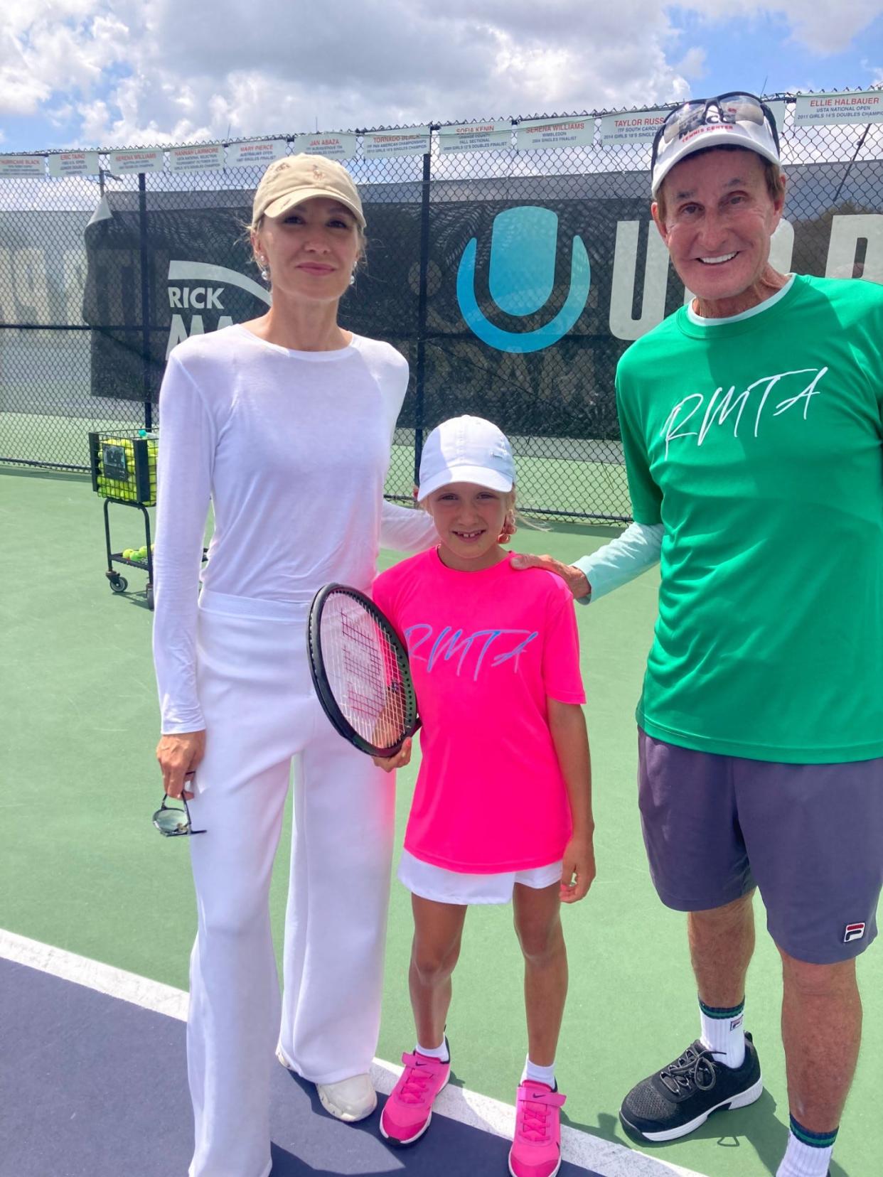Maryna Hrancher and her daughter Vlada pose with Rick Macci on the court at Boca Raton's Rick Macci Tennis Academy.