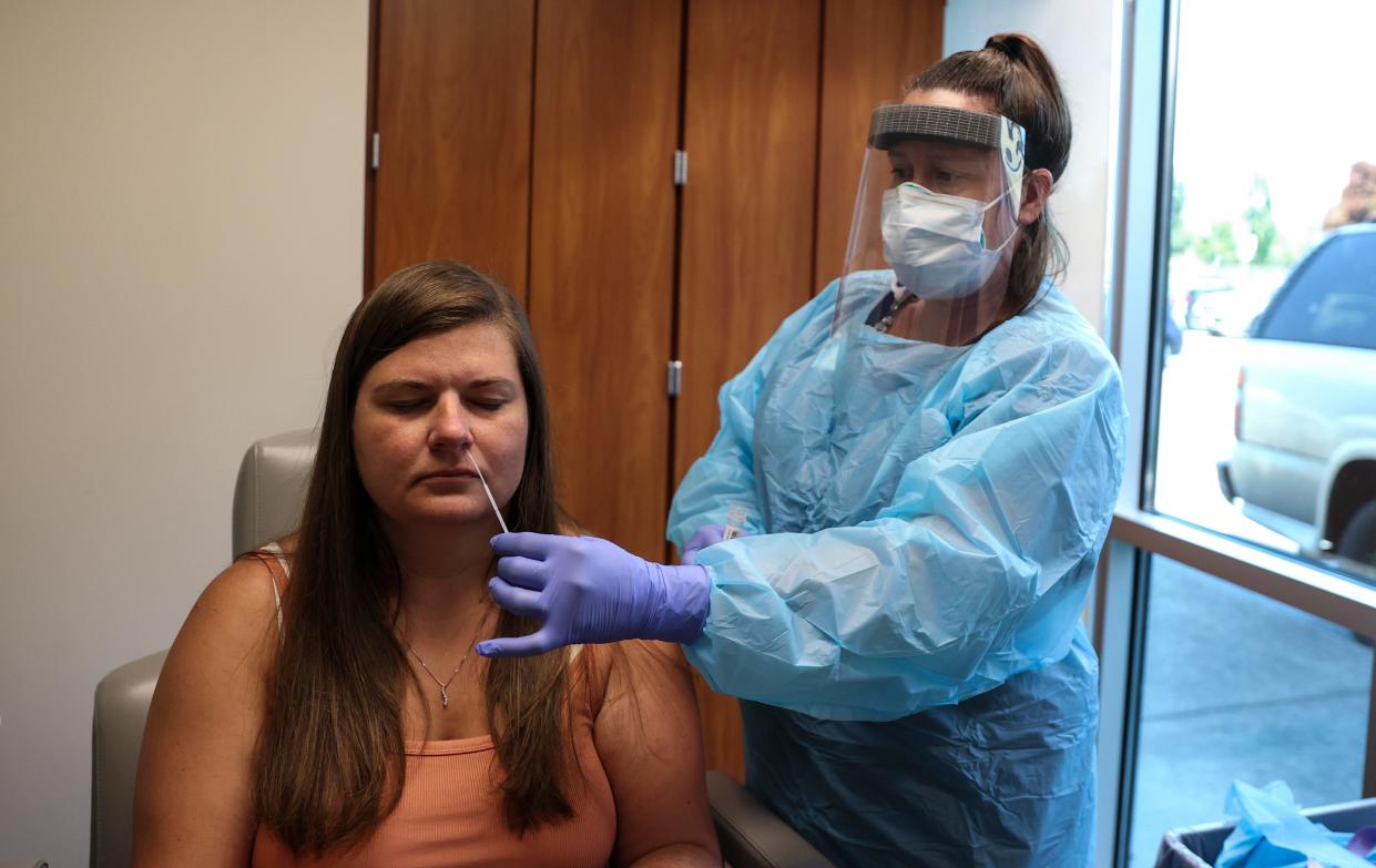 Phlebotomist April Aymong administers a nasopharyngeal swab to test for COVID-19 on Amy Adams at Salem Health Laboratory in Salem on July 12.