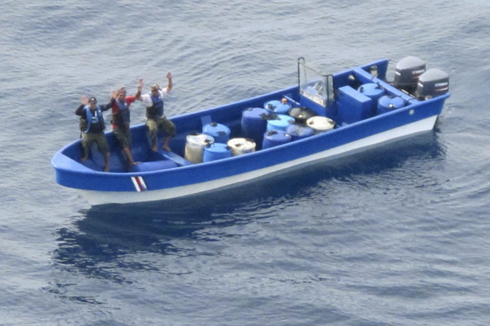 In this photo obtained from U.S. federal court records, Jeffri Dávila-Reyes, third from left, and two others hold their hands in the air as they are intercepted in the Caribbean Sea on Oct. 29, 2015. Dávila-Reyes says he’s still mystified how he ended up serving hard time in a U.S. federal prison. His cocaine bust at sea was closer to his homeland of Costa Rica than the United States, and the few kilos of drugs he was carrying were bound for Jamaica rather than American shores. (U.S. Coast Guard via AP)