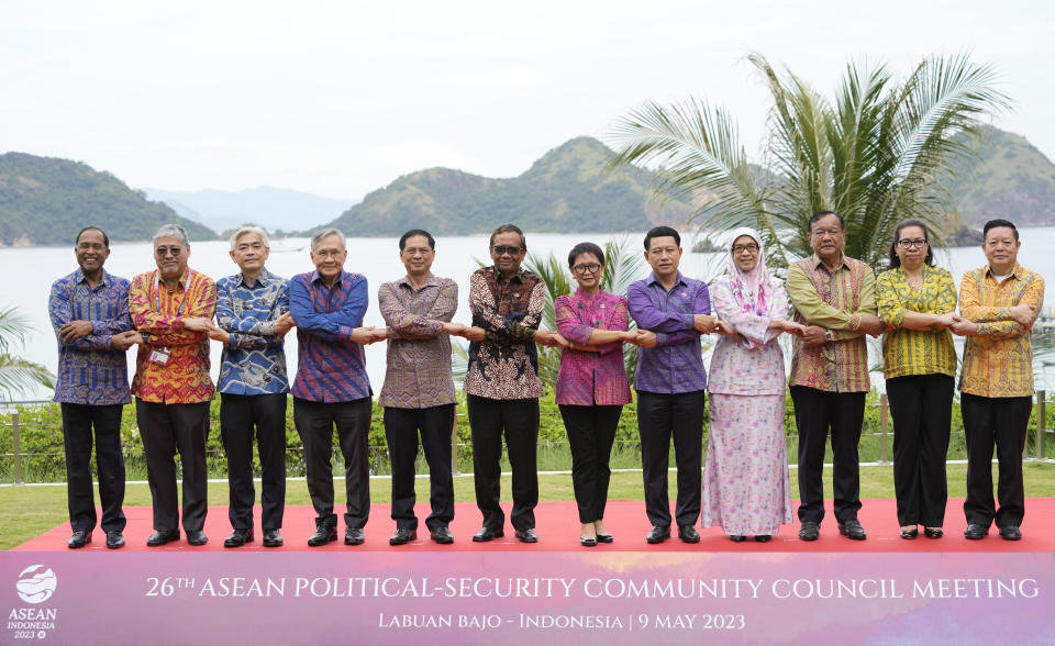 From left, Malaysia's Foreign Minister Zambry Abd Kadir, Philippines' Secretary of Foreign Affairs Enrique Manalo, Singapore's head of senior official delegate Albert Chua, Thailand's Foreign Minister Don Pramudwinai, Vietnam's Foreign Minister Bui Thanh Son, Indonesian Coordinating Political Legal and Security Affairs Minister Mahfud, Indonesia's Foreign Minister Retno Marsudi, Laos Foreign Minister Saleumxay Kommasith, Brunei's head of senior official delegate Johariah Wahab, Cambodia's Foreign Minister Prak Sokhonn, East Timor's Foreign Minister Adaljiza Magno and ASEAN Secretary-General Kao Kim Hourn hold hands as they pose for a photo during the Association of Southeast Asian Nations (ASEAN) political security community council meeting in Labuan Bajo, East Nusa Tenggara, Indonesia, Tuesday, May 9, 2023. (AP Photo/Achmad Ibrahim, Pool)