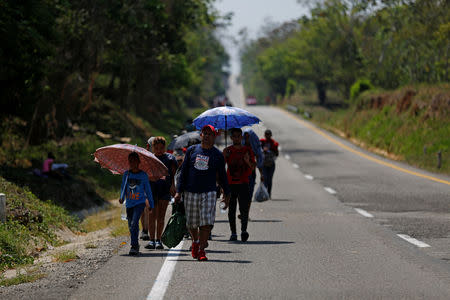 Central American migrants walk during their journey towards the United States, in Mapastepec, Mexico April 20, 2019. REUTERS/Jose Cabezas