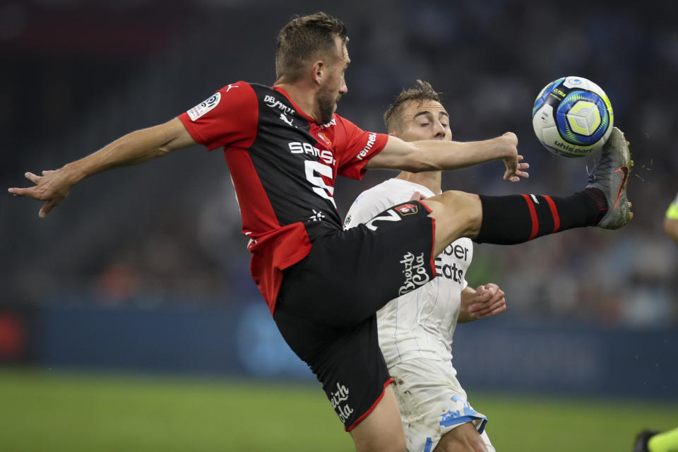 Rennes' Flavian Tait and Marseille's Valentin Rongier battle for the ball during the French League One soccer match between Marseille and Rennes at the Velodrome stadium in Marseille, southern France, Sunday, Sept. 29, 2019. (AP Photo/Daniel Cole)