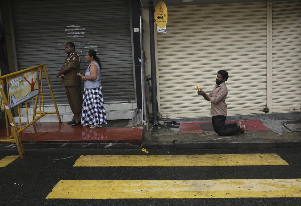 Sri Lankans light candles and pray outside St. Anthony's Church in Colombo, Sri Lanka, Tuesday, April 30, 2019. Sri Lanka is limping back to normalcy after the devastating bomb attacks on Easter Sunday that killed more than 250 people, meanwhile the archbishop said that the government's security operations to apprehend Islamic extremists who may be at large is unsatisfactory despite assurances from leaders. (AP Photo/Manish Swarup)