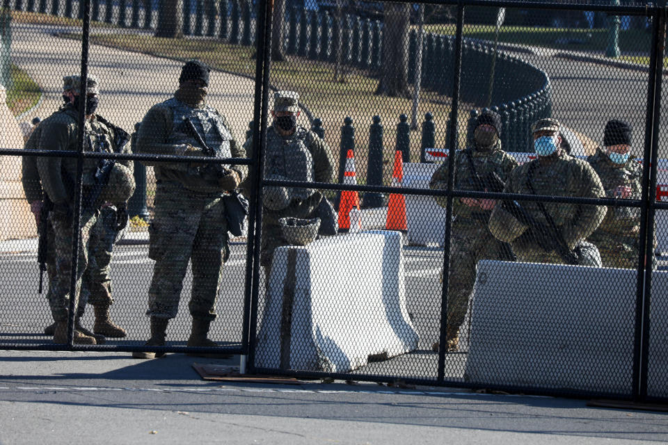 Members of the National Guard are issued weapons outside the US Capitol Wednesday. Source: Getty