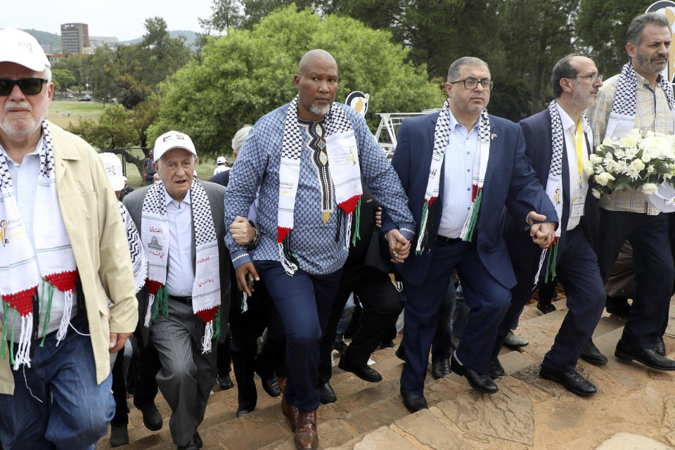 FILE — Nelson Mandela's grandson Mandla Mandela, center, with Hamas official Basem Naim, center right, during a march to commemorate the 10th anniversary of the death of former South African president Nelson Mandela at Union Building in Pretoria, South Africa, Tuesday, Dec. 5, 2023. South Africa's long-held support for the Palestinian people can be traced back to the time of Mandela and the late Palestinian leader Yasser Arafat with the two leaders believing that the struggle for freedom by Blacks in apartheid South Africa and Palestinians in Gaza and the West Bank were the same. (AP Photo, File)