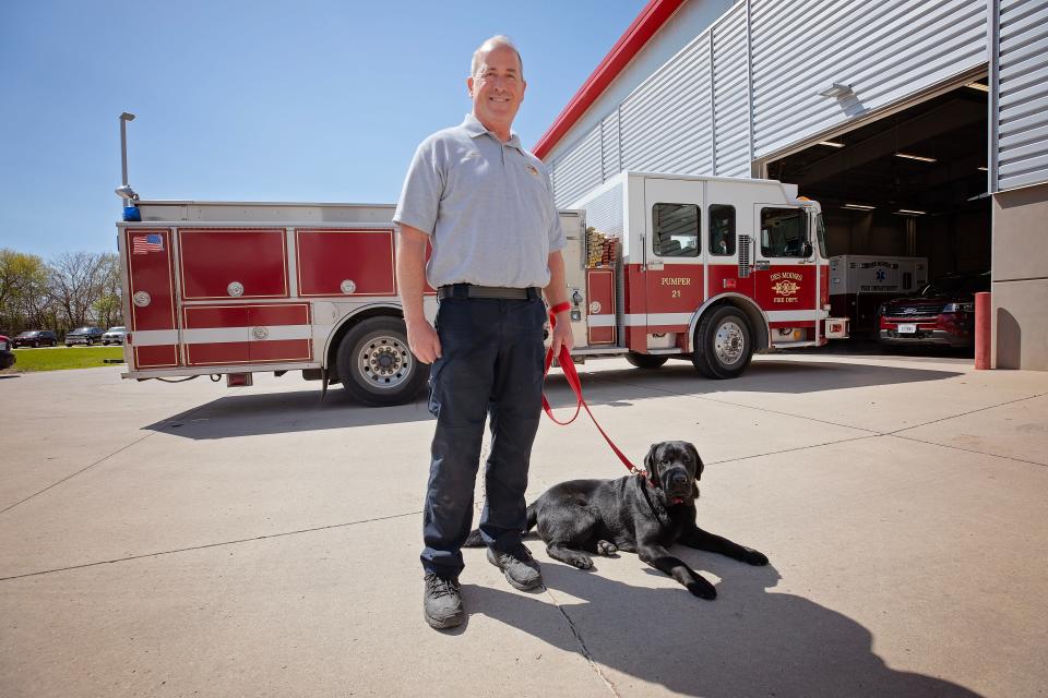 Yahtzee, the Des Moines Fire Department's new arson investigating dog, poses with his handler Capt. Eric Huntoon.