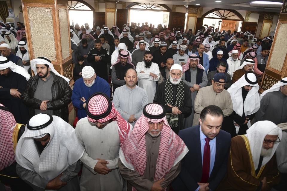 People pray during the funeral ceremony of the Emir of Kuwait Sheikh Nawaf Al Ahmad Al Sabah at the Bilal bin Rabah Mosque in Al-Siddiq district of Kuwait, Sunday, Dec. 17, 2023. Kuwait’s ruling emir, died on Saturday after a three-year, low-key reign focused on trying to resolve the tiny, oil-rich nation's internal political disputes. He was 86. (AP Photo/Jaber Abdulkhaleg)