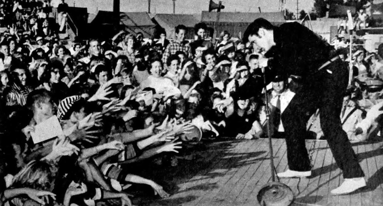 Elvis performing live at the Mississippi-Alabama Fairgrounds in Tupelo, Mississippi, 26 September 1956. <a href="https://commons.wikimedia.org/wiki/File:Elvis_Presley_-_TV_Radio_Mirror,_March_1957_01.jpg" rel="nofollow noopener" target="_blank" data-ylk="slk:Wikimedia Commons;elm:context_link;itc:0;sec:content-canvas" class="link ">Wikimedia Commons</a>