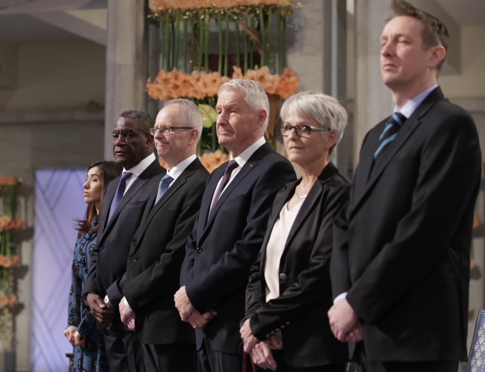 The Peace Prize laureates, from left, Nadia Murad from Iraq and Dr. Denis Mukwege from Congo, pose with Henrik Syse, Thorbjorn Jagland, Anne Enger and Asle Toje, during the Nobel Peace Prize Ceremony in Oslo Town Hall, Oslo, Monday Dec. 10, 2018. Dr. Denis Mukwege and Nadia Murad receive the Nobel Peace Prize recognising their efforts to end the use of sexual violence as a weapon of war and armed conflict. (Haakon Mosvold Larsen / NTB Scanpix via AP, Pool)