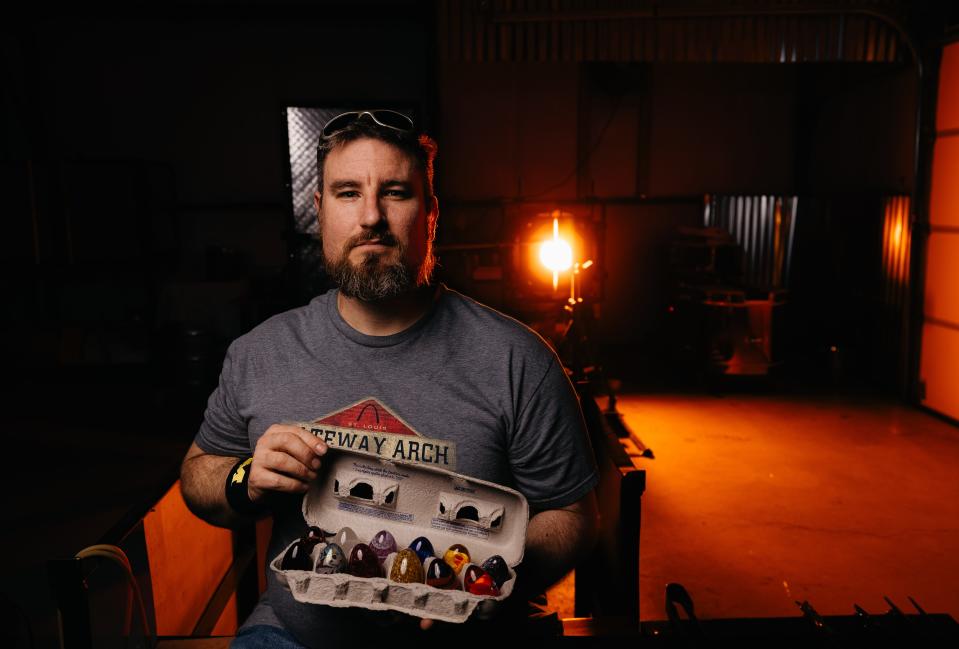 Local glass blower Eric Minton holds a dozen glass eggs he plans to hide around Bartlesville for the Easter Egg hunt set for March 30.