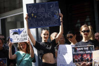 Lido cabaret employees demonstrate to try to save their jobs and the history of the cabaret, known for its dinner theater and its "Bluebell Girls" revue, Saturday, May 28, 2022 in Paris. Amid financial troubles and changing times, the venue's new corporate owner is ditching most of the Lido's staff and its high-kicking, high-glamour dance shows — which date back decades and inspired copycats from Las Vegas to Beirut — in favor of more modest musical revues. (AP Photo/Thomas Padilla)