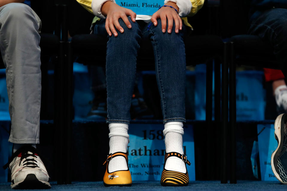 <p>Simone Kaplan, 11, of Davie, Fla., wears bee-themed shoes while competing in the 90th Scripps National Spelling Bee in Oxon Hill, Md., Wednesday, May 31, 2017. The first national spelling bee was held in 1925, and the contest was put on hold during World War II. (AP Photo/Jacquelyn Martin) </p>