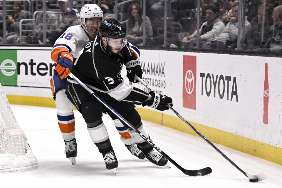 Los Angeles Kings defenseman Matt Roy (3) controls the puck away from New York Islanders left wing Pierre Engvall (18) during the third period of an NHL hockey game in Los Angeles, Monday, March 11, 2024. (AP Photo/Alex Gallardo)
