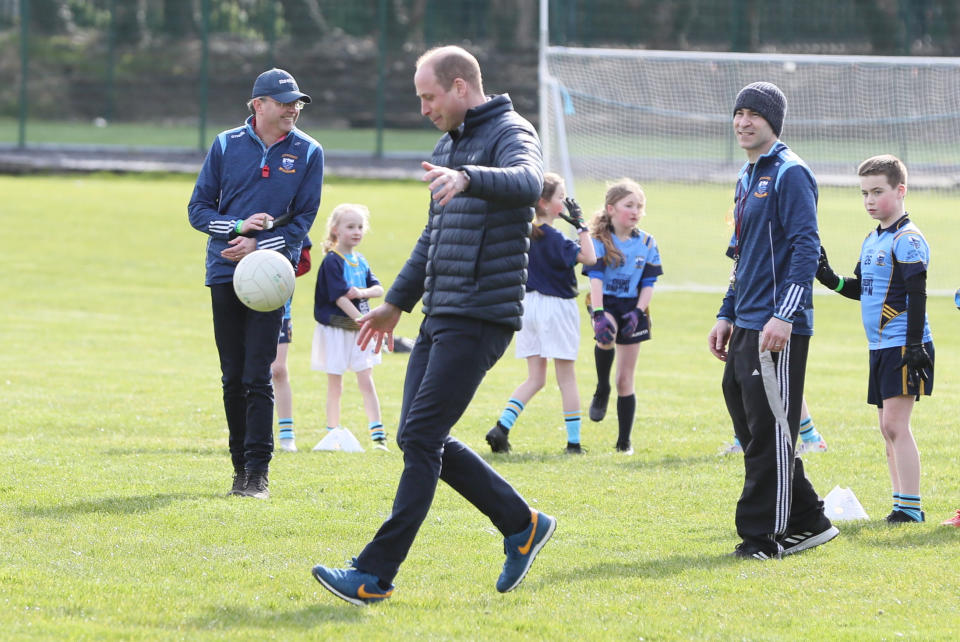 The Duke of Cambridge tries out Gaelic football during a visit to a local Gaelic Athletic Association (GAA) club to learn more about traditional sports during the third day of their visit to the Republic of Ireland.
