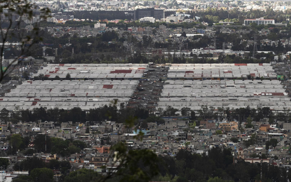 The Central de Abasto market, Mexico City's main food distribution center is seen amid the new coronavirus pandemic, Wednesday, June 3, 2020. The wholesale market installed its own testing center and triage area, and instituted contact tracing long before the city itself did, and the weekly number of new cases has since fallen, said its director, Hector Garcia Nieto. (AP Photo/Marco Ugarte)