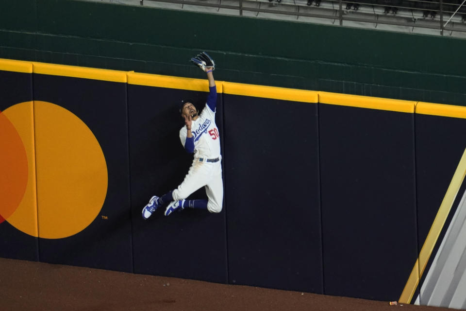 Los Angeles Dodgers right fielder Mookie Betts robs Atlanta Braves' Freddie Freeman of a home run during the fifth inning in Game 7 of a baseball National League Championship Series Sunday, Oct. 18, 2020, in Arlington, Texas. (AP Photo/David J. Phillip)