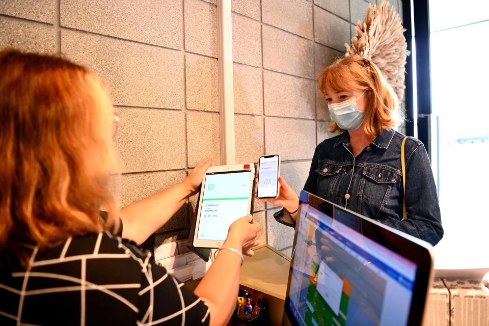 A client scans in her vaccine passport at Luxe & Duke Hairdressing on 25 November 2021 in Auckland, New Zealand (Getty Images)