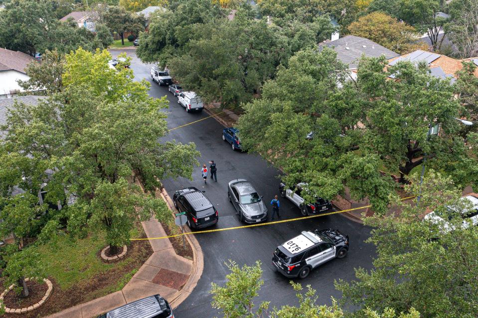 Austin Police Department vehicles block street access to a South Austin home where four people died, including an SWAT officer, and two others were injured in a standoff Saturday.