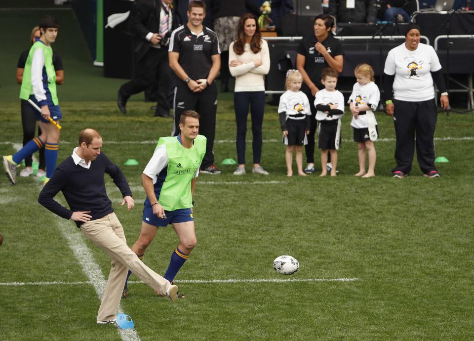 Britain's Prince William (front L) kicks off during a young players' rugby tournament held at Forsyth Barr Stadium in Dunedin April 13, 2014. Prince William and his wife are undertaking a 19-day official visit to New Zealand and Australia with their son, Prince George. REUTERS/Phil Noble (NEW ZEALAND - Tags: ENTERTAINMENT ROYALS SPORT RUGBY)