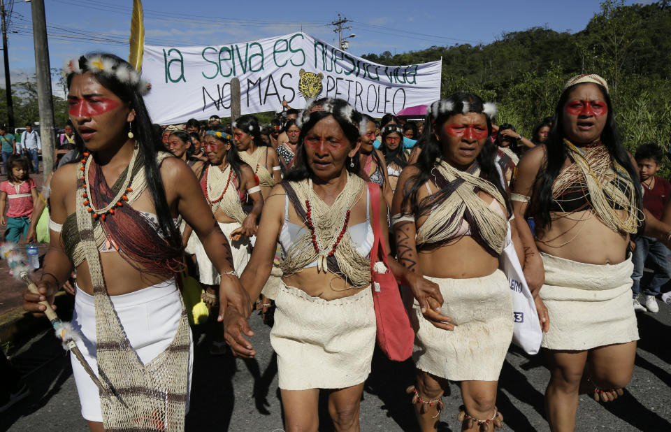 Waoranis march to a courthouse to attend the ruling on a lawsuit filed by the Waoranis against the Ministry of Non-Renewable Natural Resources for opening up oil concessions on their ancestral land, in Puyo, Ecuador, Friday, April 26, 2019. The judge went on to rule in favor of the Waoranis. (AP Photo/Dolores Ochoa)