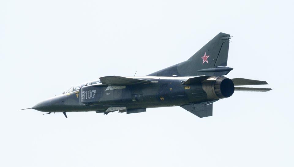 A MiG-23 aircraft is seen in the air moments before crashing during the Thunder over Michigan air show at the Willow Run Airport in Ypsilanti on Sunday. Two people reportedly ejected from the aircraft prior to the crash.