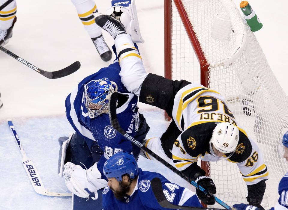 Tampa Bay Lightning goaltender Andrei Vasilevskiy (88) dumps Boston Bruins center David Krejci (46) during the third period in Game 1 of an NHL hockey second-round playoff series, Sunday, Aug. 23, 2020, in Toronto. (Frank Gunn/The Canadian Press via AP)