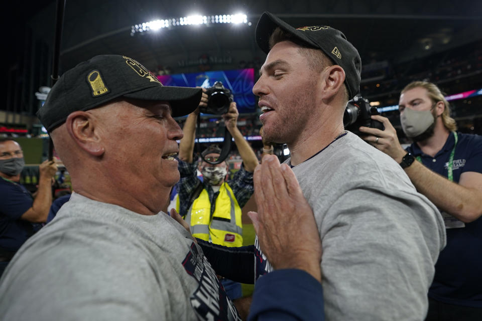 Atlanta Braves manager Brian Snitker and first baseman Freddie Freeman celebrate after winning baseball's World Series in Game 6 against the Houston Astros Tuesday, Nov. 2, 2021, in Houston. The Braves won 7-0. (AP Photo/David J. Phillip)