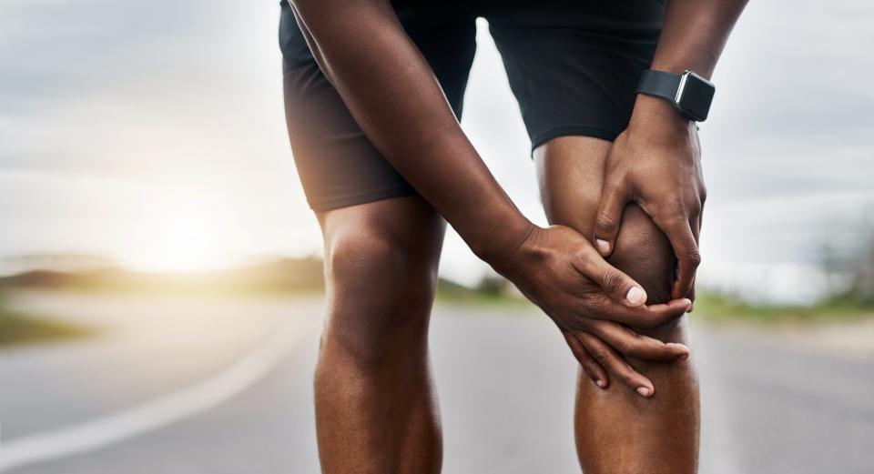 Man massages knee during raceGetty Images