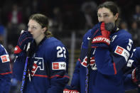 United States forward Tessa Janecke, left, and defensewoman Megan Keller react as they watch Canada celebrate their win in the final at the IIHF Women's World Hockey Championships in Utica, N.Y., Sunday, April 14, 2024. (AP Photo/Adrian Kraus)