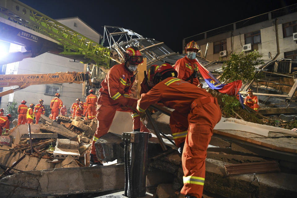 In this photo released by Xinhua News Agency, rescuers prepare equipment as they search for survivors at a collapsed hotel in Suzhou in eastern China's Jiangsu Province on Monday, July 12, 2021. The hotel building collapsed Monday afternoon. (Li Bo/Xinhua via AP)