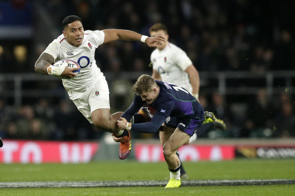 FILE - In this March 16, 2019, file photo, England's Manu Tuilagi, left, is tackled by Scotland's Darcy Graham during the Six Nations rugby union international between England and Scotland at Twickenham stadium in London. England has had wild fortunes this Rugby World Cup cycle under Eddie Jones but appears to be running into good form ahead of the tournament in Japan. (AP Photo/Tim Ireland File)