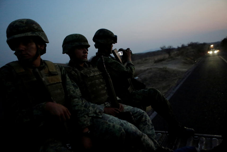 <p>Soldiers sit atop a military vehicle as they arrive for an operation to destroy a poppy field in the municipality of Coyuca de Catalan, Mexico, April 18, 2017. (Photo: Henry Romero/Reuters) </p>