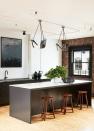 <p>The exposed brick and piping in this industrial space allow for an edgy, gritty backdrop while the streamlined island and cabinets tighten up the space. For a super clean, sleek look, ditch overhead cabinets and floating shelves. </p>