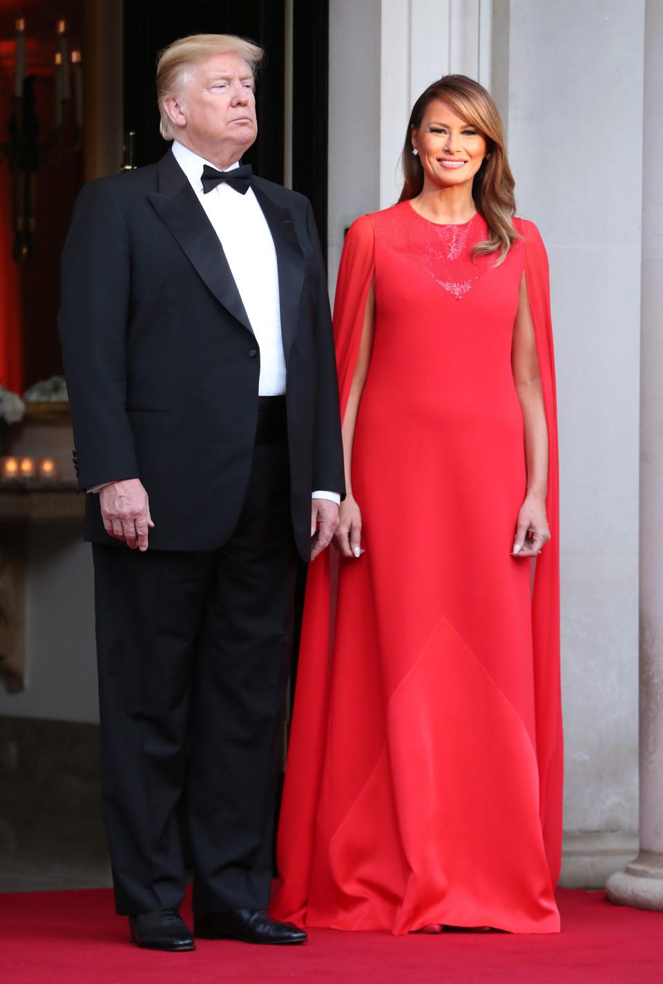 The US First Lady chose a sweeping red caped gown for the state dinner [Photo: Getty]