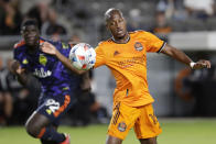 Houston Dynamo midfielder Fafa Picault, right, brings down the ball in front of Seattle Sounders defender Abdoulaye Cissoko (92) during the first half of an MLS soccer match Saturday, Oct. 16, 2021, in Houston. (AP Photo/Michael Wyke)