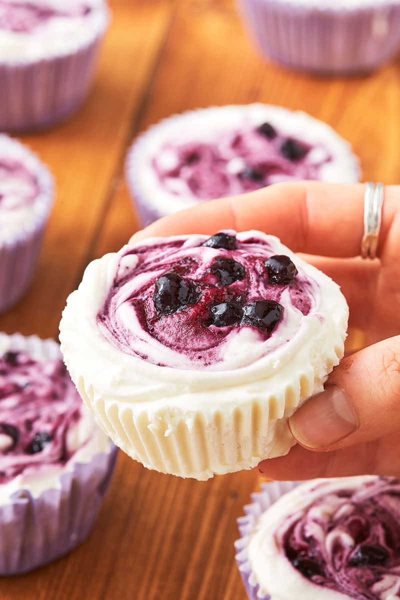 <p>Mini cheesecakes, MASSIVE flavour. This recipe really has everything you could want. </p><p>Get the <a href="https://www.delish.com/uk/cooking/recipes/a32298682/lemon-blueberry-mini-cheesecakes-recipe/" rel="nofollow noopener" target="_blank" data-ylk="slk:Lemon Blueberry Mini Cheesecakes;elm:context_link;itc:0;sec:content-canvas" class="link ">Lemon Blueberry Mini Cheesecakes</a> recipe.</p>