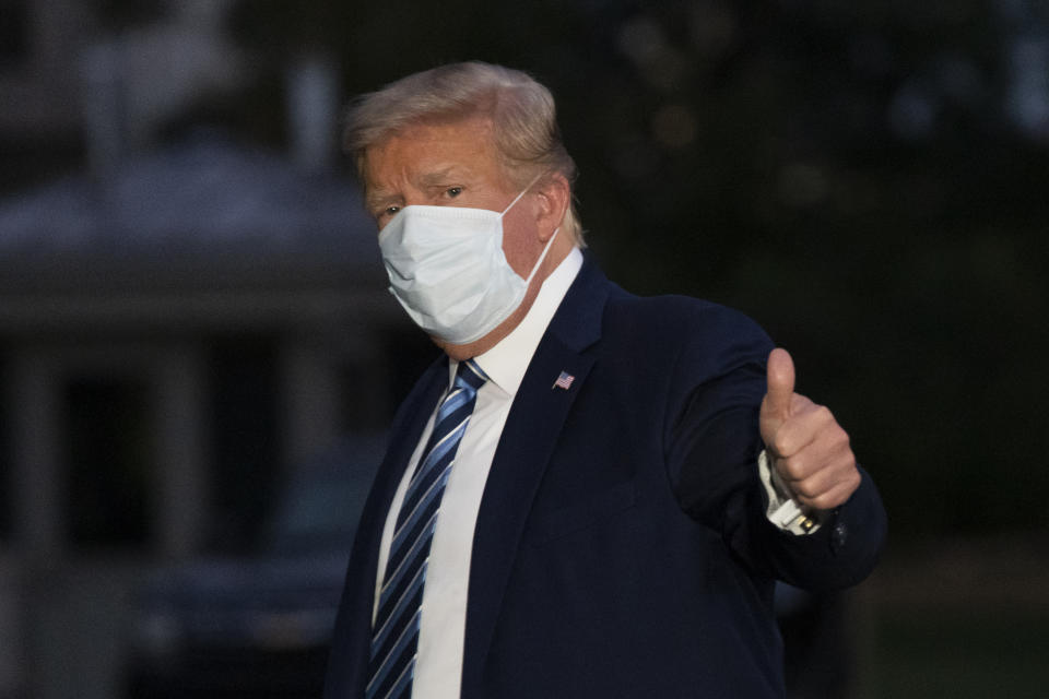 President Donald Trump gives thumbs up as he returns to the White House Monday, Oct. 5, 2020, in Washington, after leaving Walter Reed National Military Medical Center, in Bethesda, Md. Trump announced he tested positive for COVID-19 on Oct. 2. (AP Photo/Alex Brandon)